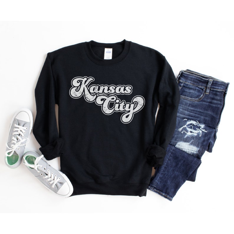 May include: Black sweatshirt with a white vintage-style graphic that says "Kansas City".