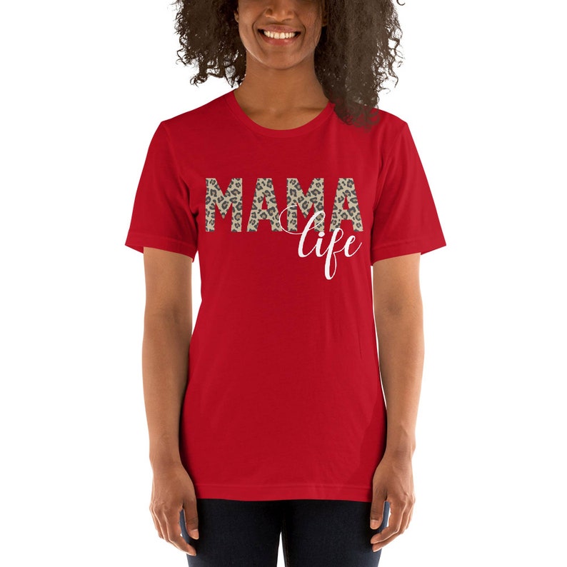 May include: Red short-sleeved t-shirt with the text "MAMA life" in white with a leopard print pattern behind the word "MAMA".