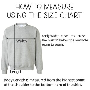 May include: Diagram showing how to measure the width and length of a sweatshirt. The width is measured across the bust 1 inch below the armhole, seam to seam. The length is measured from the highest point of the shoulder to the bottom hem.