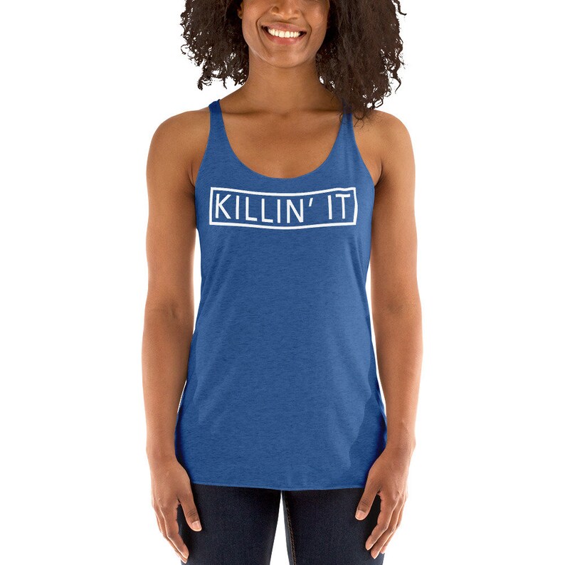 May include: A blue sleeveless tank top with the text "KILLIN' IT" in a white rectangle on the front.