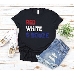 May include: Black t-shirt with the text "RED WHITE & BOOZE" in red, white, and blue with a distressed look. The text is overlaid with a pattern of red, white, and blue stars.