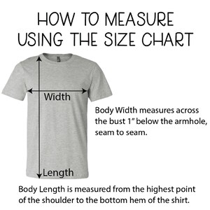 May include: Diagram showing how to measure the width and length of a t-shirt. The width is measured across the bust 1 inch below the armhole, seam to seam. The length is measured from the highest point of the shoulder to the bottom hem of the shirt.