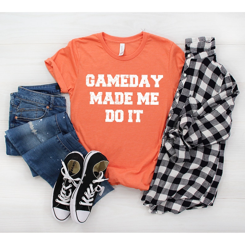 May include: Orange t-shirt with the text "GAMEDAY MADE ME DO IT" in white distressed lettering.