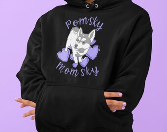 May include: Black hooded sweatshirt with a purple graphic of a Pomsky dog with hearts and the text "pomsky mom sky".
