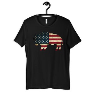 May include: A black t-shirt with a distressed American flag design in the shape of a buffalo.