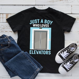 May include: Black t-shirt with a graphic of a lift and the text "Just a boy who loves elevators".