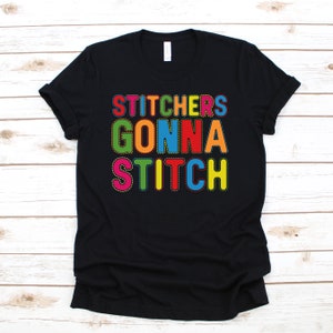 May include: Black t-shirt with the text "Stitchers Gonna Stitch" in colourful letters with a stitched outline.