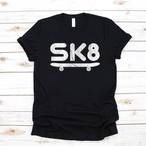 May include: Black t-shirt with a white graphic of a skateboard and the text "SK8".