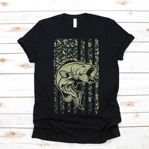 May include: Black t-shirt with a camouflage American flag design featuring a bass fish jumping out of the water.