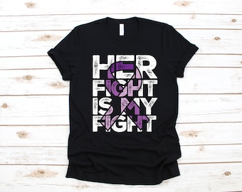 May include: Black t-shirt with a white graphic design that says "HER FIGHT IS MY FIGHT" with a purple ribbon incorporated into the design.