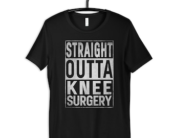 May include: Black t-shirt with a white graphic that says "STRAIGHT OUTTA KNEE SURGERY".