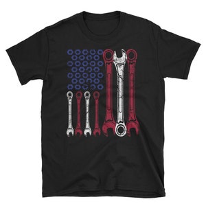 May include: Black t-shirt with a graphic of a wrench-shaped American flag. The flag is made up of wrenches in red, white, and blue.