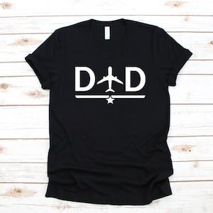 May include: Black t-shirt with a white graphic of the word "DAD" with an airplane in between the letters and a star below the letters.