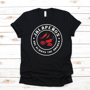 May include: Black t-shirt with a white circle graphic that says "Jalapeños are always the answer" with a red pepper illustration.