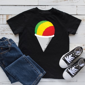 May include: Black t-shirt with a graphic of a red, yellow, and green snow cone on a white cone.