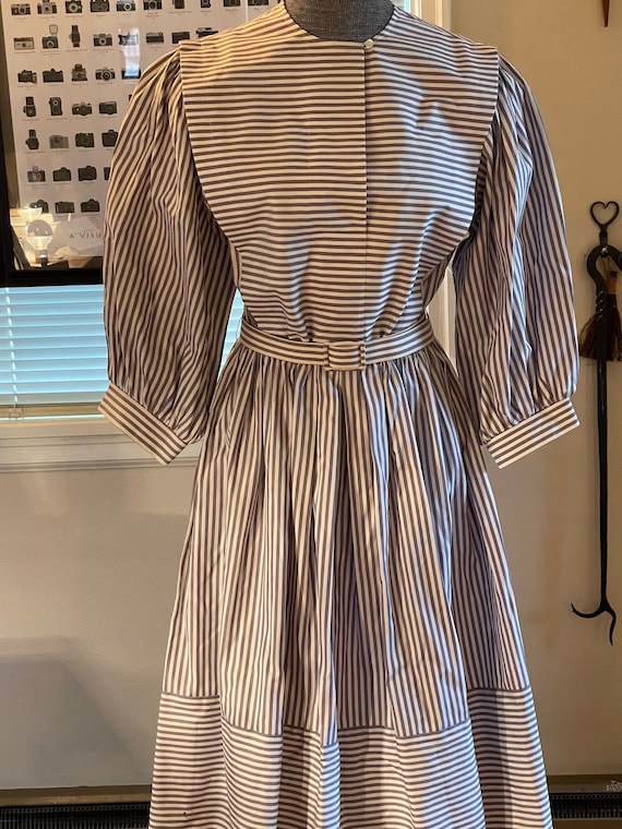 Lavender striped dress with puffed sleeves.