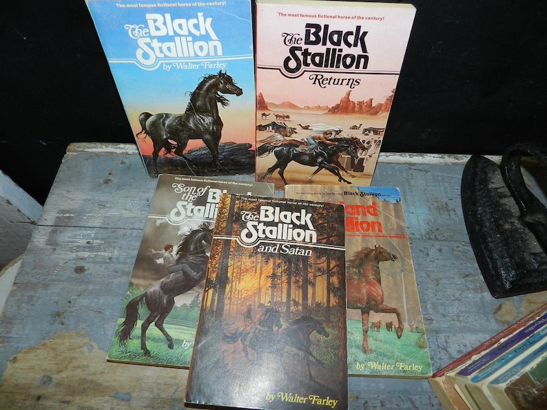 May include: A collection of vintage paperback books featuring the title "The Black Stallion" by Walter Farley. The covers showcase illustrations of horses in various settings, with titles like "Returns" and "and Satan".
