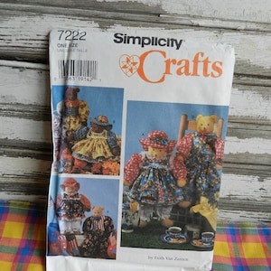 May include: Simplicity Crafts sewing pattern number 7222, featuring four teddy bear designs. The pattern includes instructions for making a teddy bear wearing a red and white gingham dress, a teddy bear wearing a blue and white floral dress, a teddy bear wearing a blue and white gingham dress, and a teddy bear wearing a red and white floral dress. The pattern is by Faith Van Zanten.