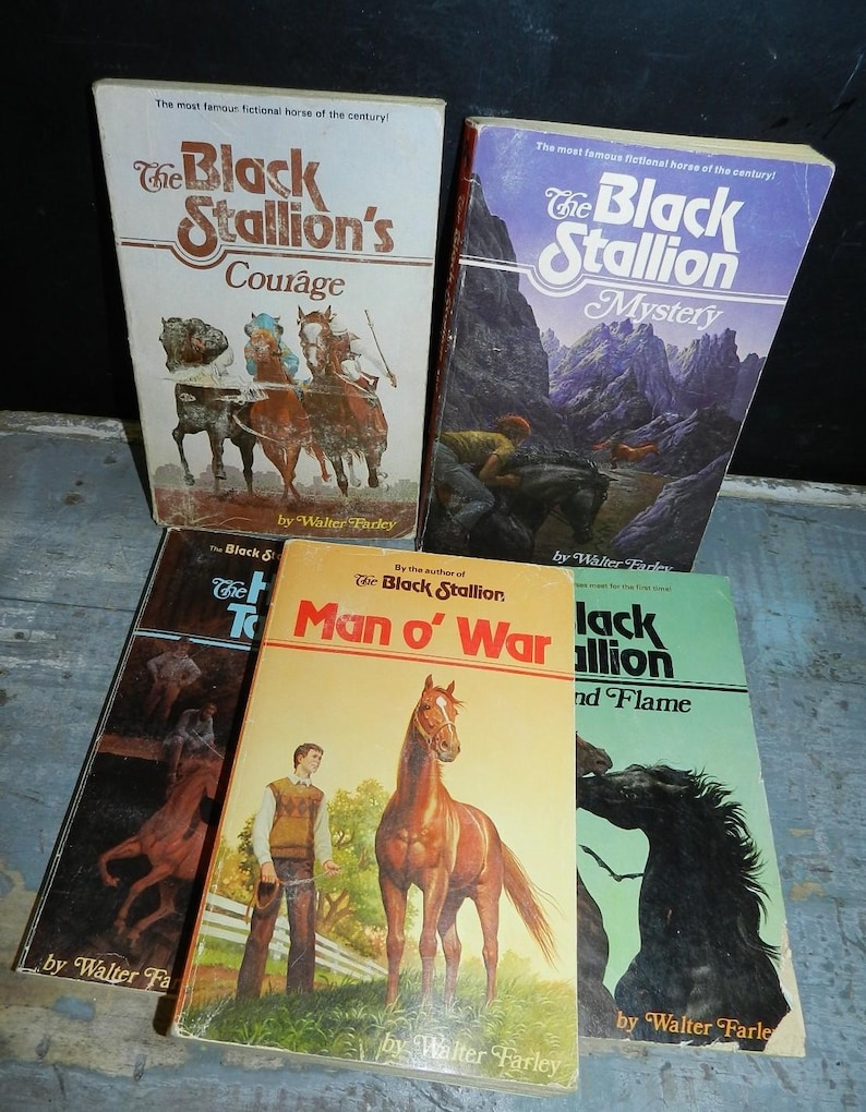 May include: A collection of vintage paperback books featuring "The Black Stallion" series by Walter Farley. The covers display illustrations of horses and riders, with titles like "Courage," "Mystery," and "Man o' War."