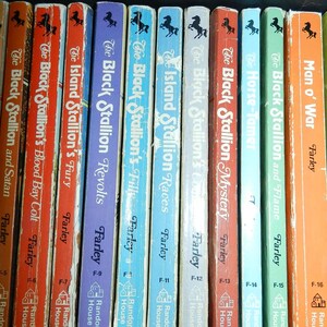 May include: A collection of vintage children's books featuring titles like "The Black Stallion" series by Farley. The books have colorful spines with titles and author names, and a horse silhouette. Published by Random House.