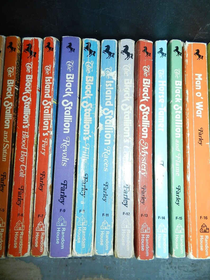 May include: A collection of vintage children's books featuring titles like "The Black Stallion" series by Farley. The books have colorful spines with titles and author names, and a horse silhouette. Published by Random House.