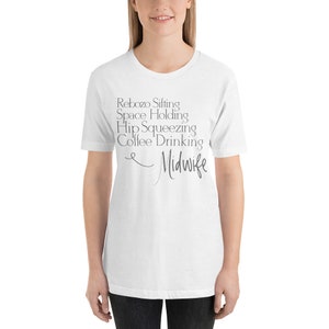 May include: White t-shirt with grey text that reads "Rebozo Sifting Space Holding Hip Squeezing Coffee Drinking Midwife".