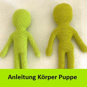 May include: Two crocheted doll bodies, one front and one back view, in a light green color. The doll bodies are made of yarn and have a simple design. The text "Anleitung Körper Puppe" is visible at the bottom of the image.