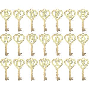 May include: A collection of gold-colored key charms, each featuring a letter of the alphabet from A to Z. The keys have a heart-shaped top and a decorative design. The background is plain white.