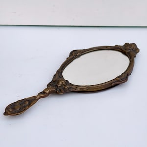 Antique bronse hand mirror with cherub Small ornate Victorian vanity mirror