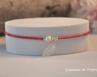 Red miyuki bracelet and watermarked leaf