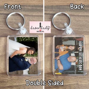 May include: Double-sided clear acrylic keyring with a silver ring. One side shows a photo of a bride and a man in a navy suit. The other side has a photo of a man and a child with the text "Happy Fathers Day".