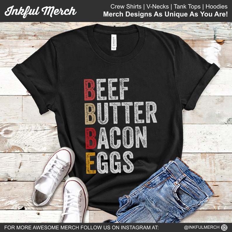 May include: Black t-shirt with a vintage-style graphic that reads "BEEF BUTTER BACON EGGS".