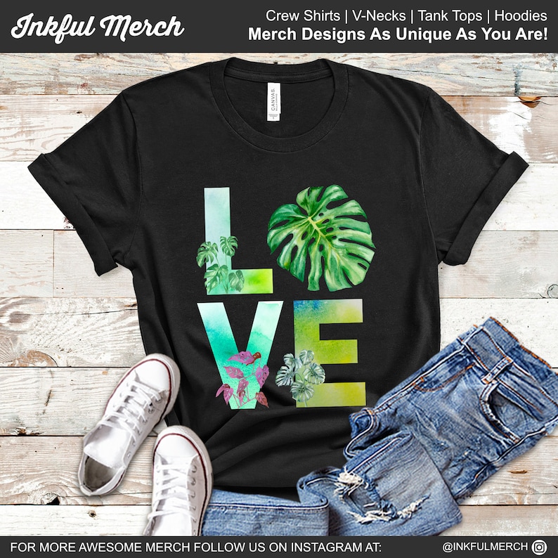 May include: Black t-shirt with a watercolor design of the word "LOVE" with green leaves and plants. The text "Inkful Merch" is at the top of the image. The text "Crew Shirts | V-Necks | Tank Tops | Hoodies" is at the top of the image. The text "Merch Designs As Unique As You Are!" is at the top of the image. The text "FOR MORE AWESOME MERCH FOLLOW US ON INSTAGRAM AT: @INKFULMERCH" is at the bottom of the image.