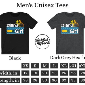May include: Unisex t-shirt with the text "Island Girl" in a colorful, retro font. The shirt is available in black and dark grey heather. A size chart shows the width and length in inches for sizes XS to 3XL.