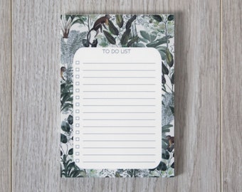 May include: A white to-do list notepad with a green, brown, and white floral design. The notepad has a title that says "To Do List".