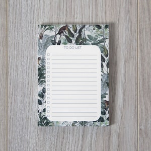 May include: A white to-do list notepad with a green, brown, and white floral design. The notepad has a title that says "To Do List".