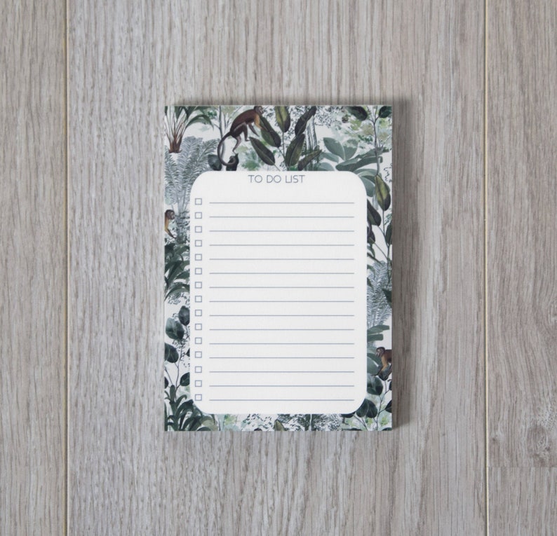 May include: A white to-do list notepad with a green, brown, and white floral design. The notepad has a title that says "To Do List".