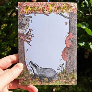 May include: A greetings card with the words "Autumn Thoughts" at the top. The card depicts an owl, squirrel, and badger in a woodland scene. The artist's signature, "kerry dilks", is at the bottom of the card.