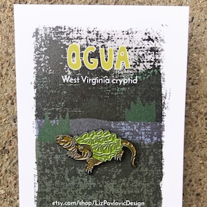 Ogua enamel pin