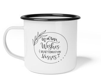 May include: White enamel mug with a black rim. The mug has a black and white design with the text "Warm Wishes & Marshmallow Kisses" in a circle with a leaf design.