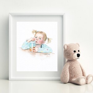 May include: A watercolor painting of a young girl with blonde pigtails drinking from a clear cup with a straw. She is wearing a light blue shirt with a floral pattern. The painting is framed in a white frame.