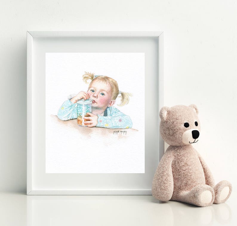 May include: A watercolor painting of a young girl with blonde pigtails drinking from a clear cup with a straw. She is wearing a light blue shirt with a floral pattern. The painting is framed in a white frame.