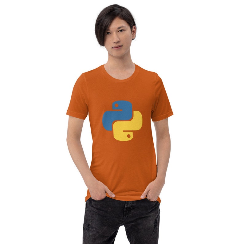 May include: A person wearing an orange t-shirt with the Python programming language logo printed on the front.