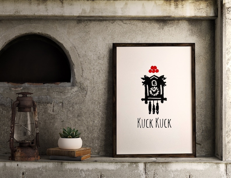 May include: Black and white illustration of a cuckoo clock with red accents. The clock is framed and hanging on a wall. The text "Kuck Kuck" is written below the clock.