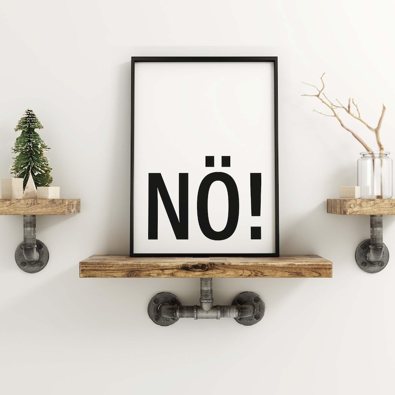 May include: A black framed print with the word "N&Ouml;!" in bold white letters on a white background. The print is hanging on a wooden shelf with metal pipe brackets.