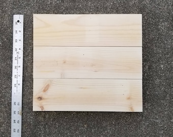 May include: A wooden sign with three horizontal planks, each with a natural wood grain. The sign is approximately 30 cm wide and 46 cm tall.