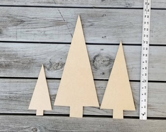 May include: Three wooden Christmas tree shapes in various sizes. The largest tree is approximately 12 inches tall, the middle tree is approximately 8 inches tall, and the smallest tree is approximately 6 inches tall.