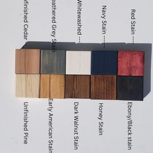 May include: Wood stain color chart with 10 different wood stain colors. The colors are: Red Stain, Ebony/Black Stain, Navy Stain, Honey Stain, Whitewashed, Dark Walnut Stain, Weathered Grey Stain, Early American Stain, Unfinished Cedar, and Unfinished Pine.