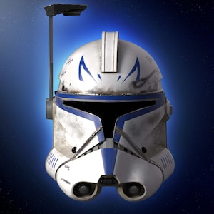 May include: A white and blue helmet with a visor and a black antenna. The helmet has blue markings and a weathered appearance. The background is a gradient of blue with a starry effect. This is a Star Wars themed item.