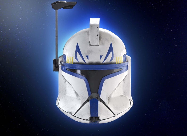 May include: A white and blue helmet with a visor, featuring blue markings and yellow accents. The helmet has a weathered appearance and a communication device attached. The design is reminiscent of a science fiction or military theme.